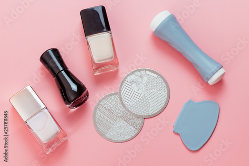 Nail stamping basic tools - nail polishes, metal plates with ornaments, stamper, scraper. Manicure accessories.