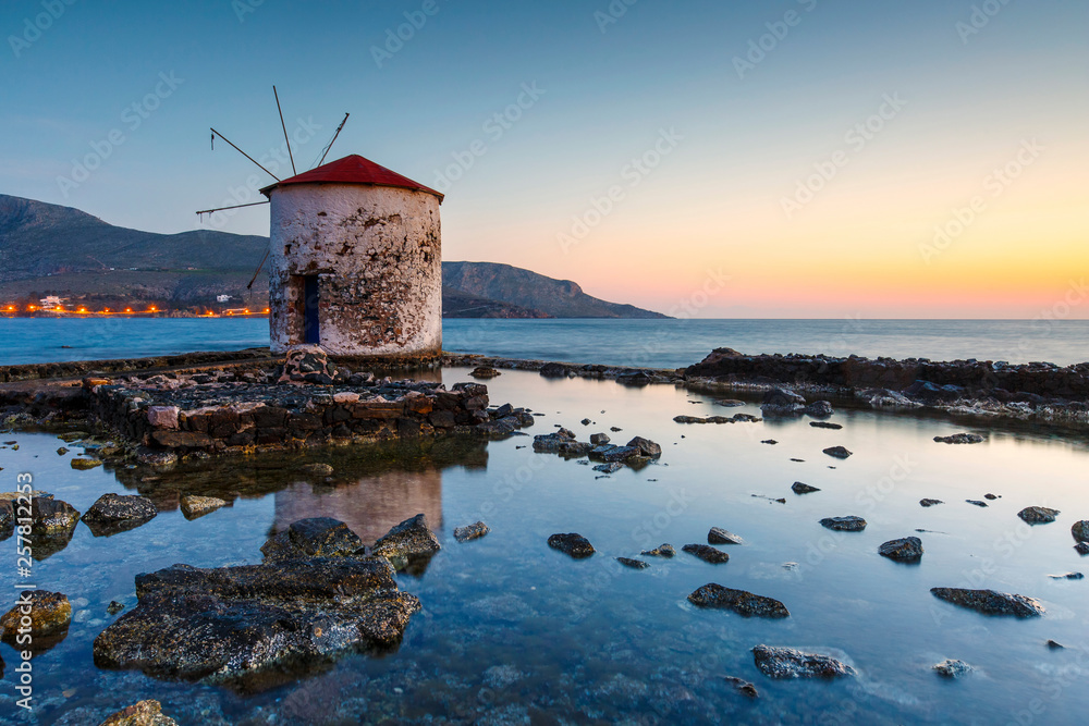 Sunrise landscape with a windmill in Agia Marina village on Leros island in Greece. 