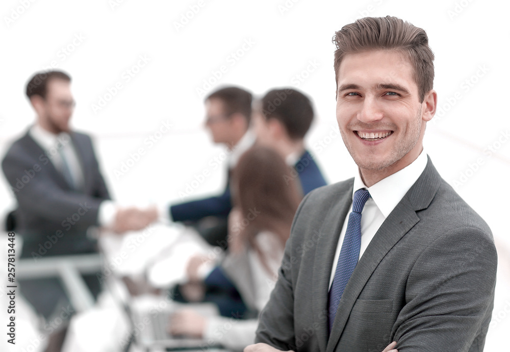 young businessman on blurred office background young businessman on blurred office background