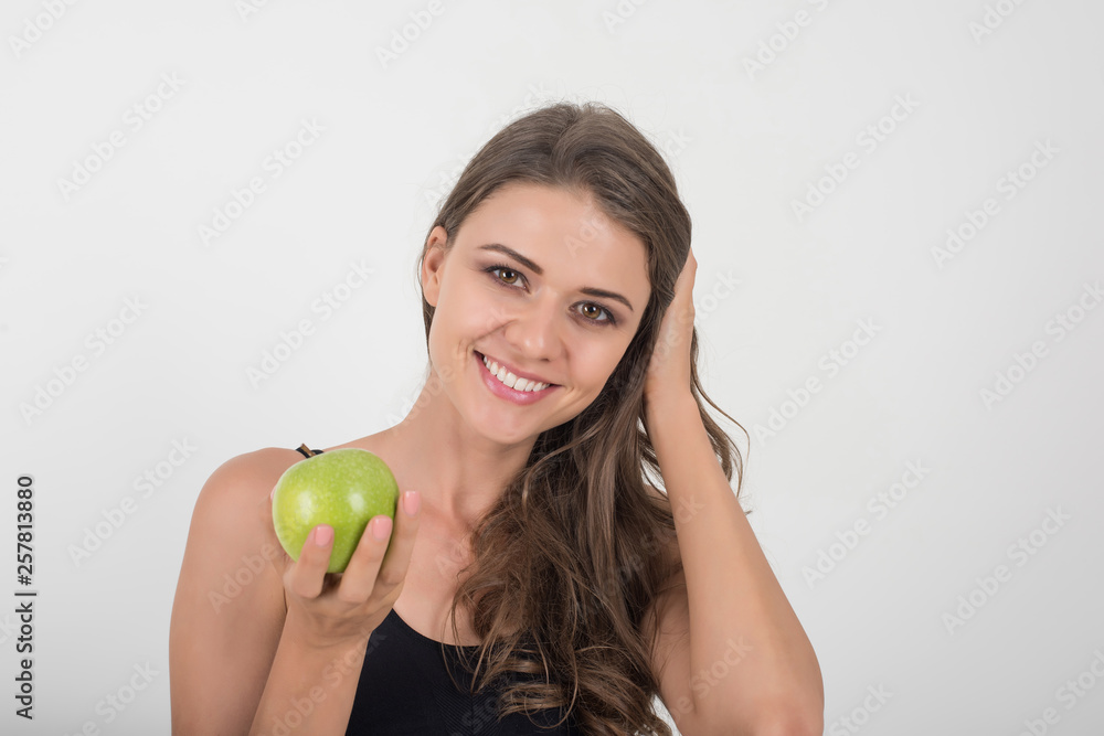 Beauty woman holding green apple while isolated on white Beauty woman holding green apple while isolated on white