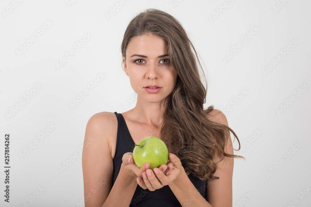 Beauty woman holding green apple while isolated on white Beauty woman holding green apple while isolated on white