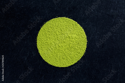 matcha green tea powder on black slate background