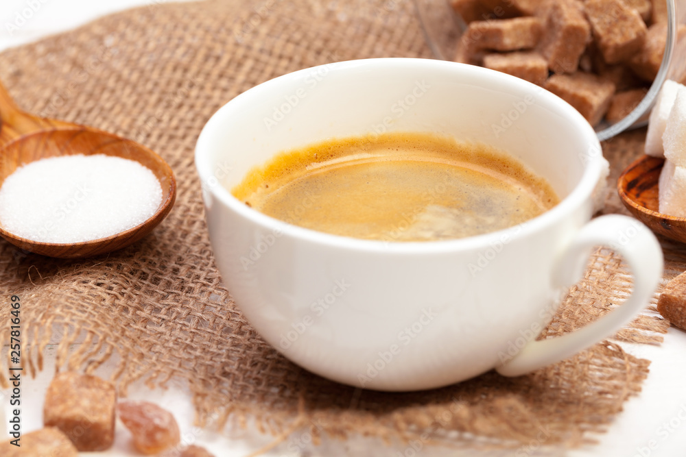 Coffee mug with slices of sugar on wooden table Coffee mug with slices of sugar on wooden table