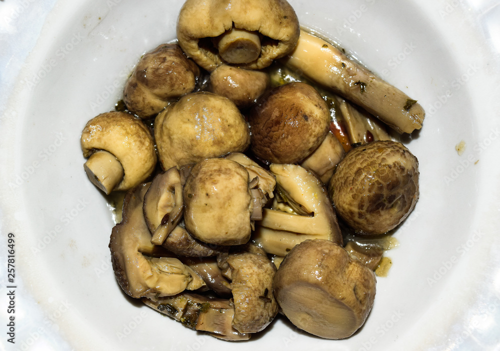 Boiled champignon mushrooms in white plate Boiled champignon mushrooms in white plate