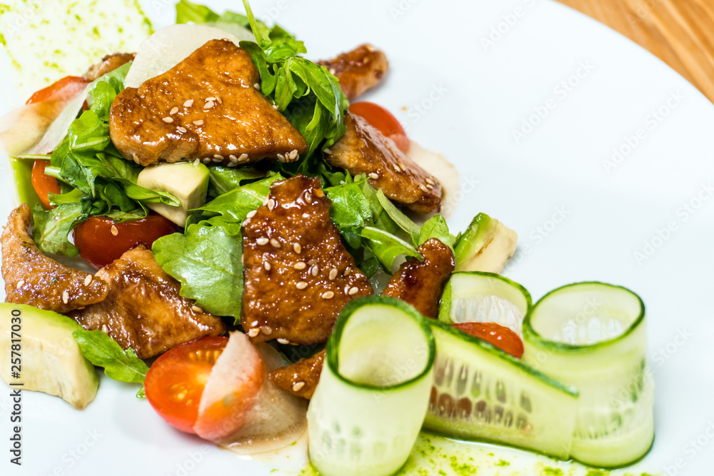 salad of fresh cucumbers and tomatoes fried meat on a wooden table salad of fresh cucumbers and tomatoes fried meat on a wooden table