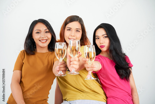 Happy women friends with champagne