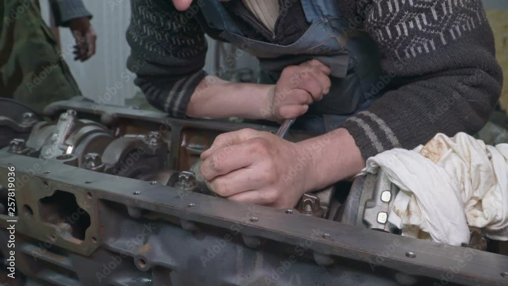 Mechanic repairing a truck engine Mechanic repairing a truck engine