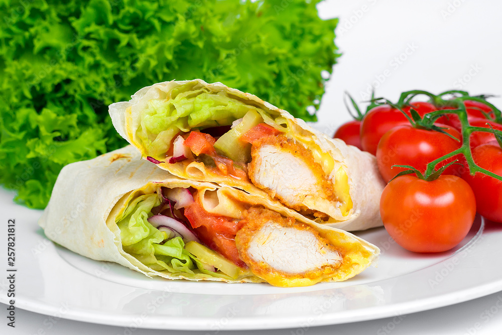 Chicken Shaverma or Doner Kebab with Vegetables on a White Plate Close Up. Chicken Shaverma or Doner Kebab with Vegetables on a White Plate Close Up.
