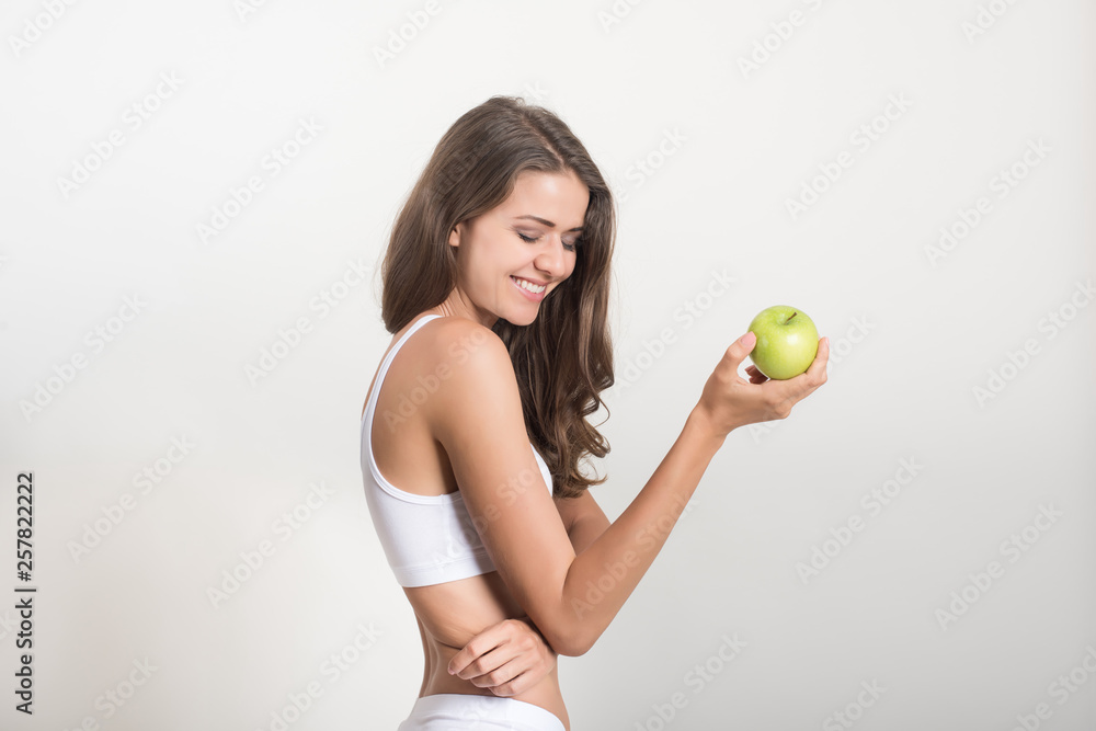Beauty woman holding green apple while isolated on white Beauty woman holding green apple while isolated on white