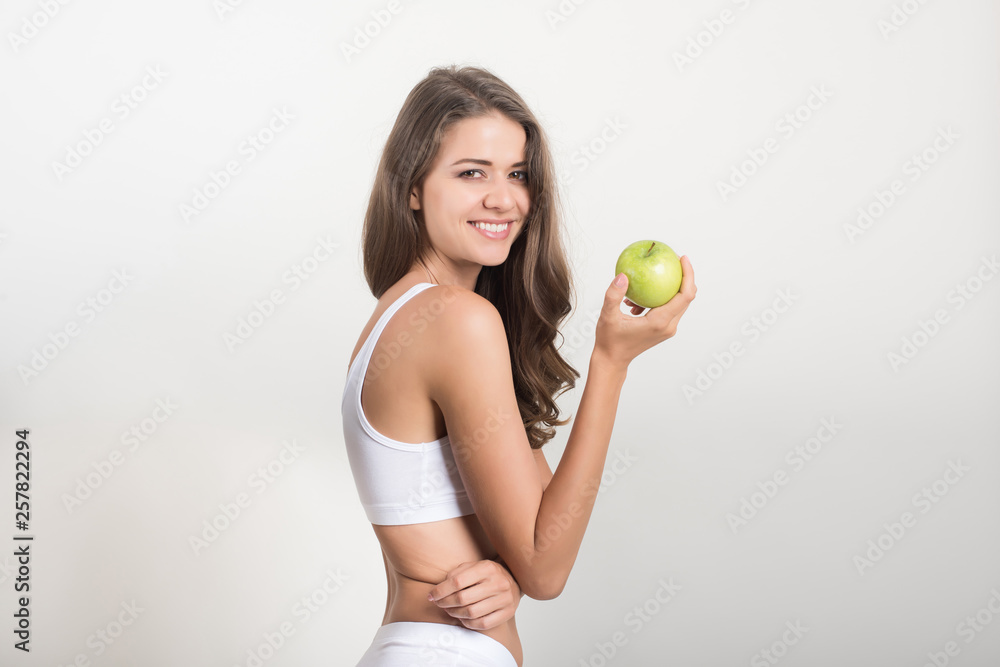 Beauty woman holding green apple while isolated on white Beauty woman holding green apple while isolated on white