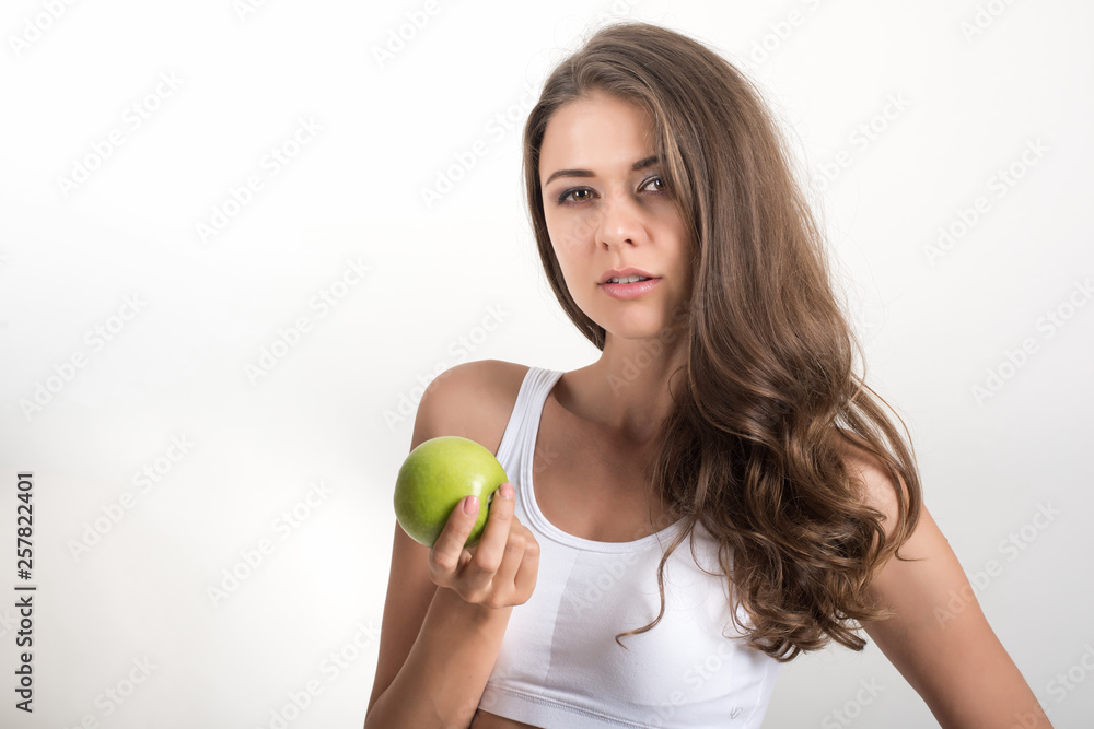Beauty woman holding green apple while isolated on white Beauty woman holding green apple while isolated on white