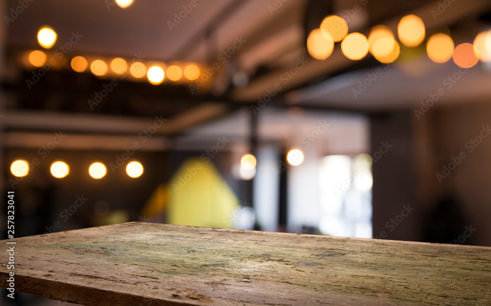 blurred background of bar and dark brown desk space of retro wood