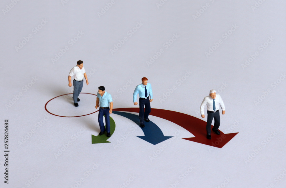Miniature people positioned in different directions. Miniature people positioned in different directions.