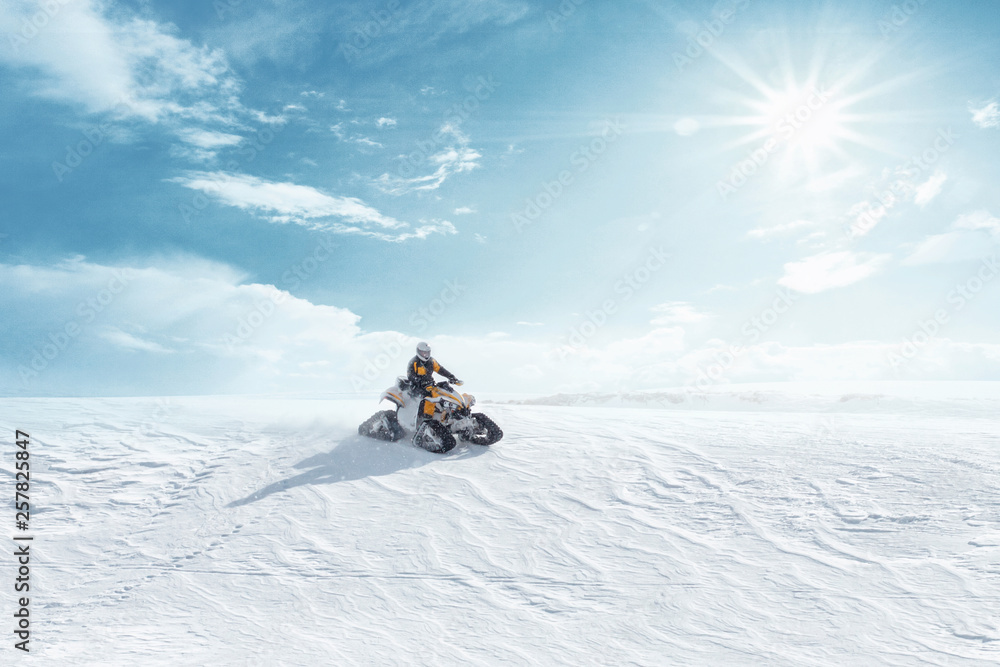 Man driving sports snowmobile in Finnish Lapland in a sunny day