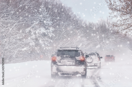 Driving in snow storm on bad winter Road © Shcherbyna
