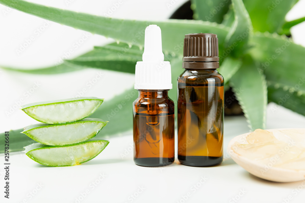 Bottle of aloe vera essential oil with fresh plant - natural beauty treatment Bottle of aloe vera essential oil with fresh plant - natural beauty treatment