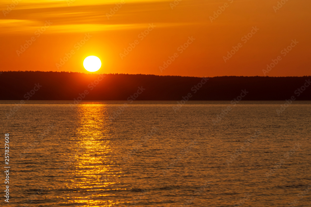 Vivid sunrise over the lake at dawning