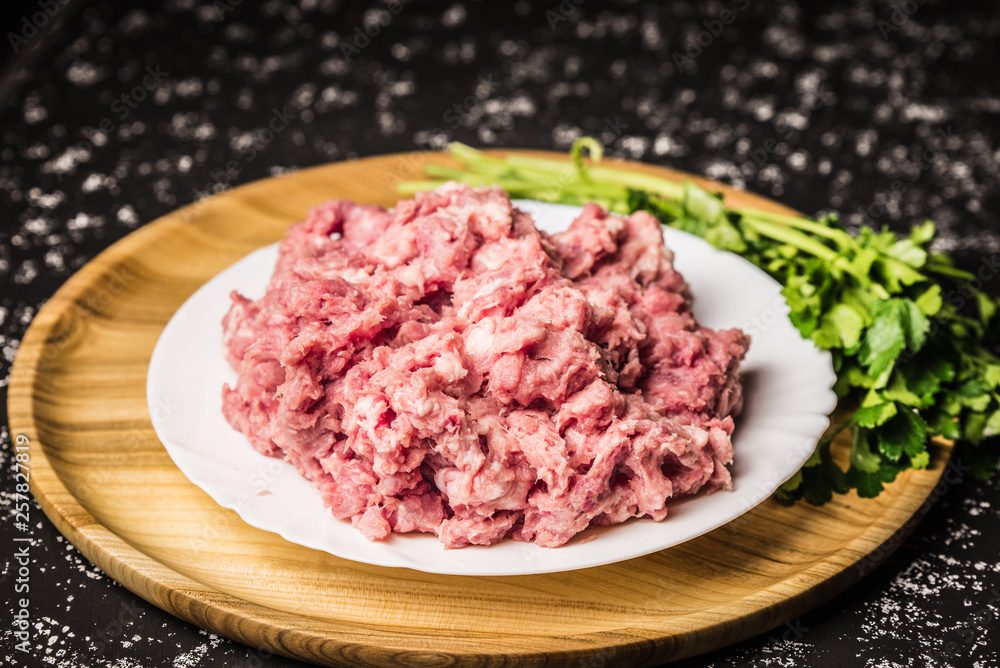 Raw minced pork on white plate Raw minced pork on white plate