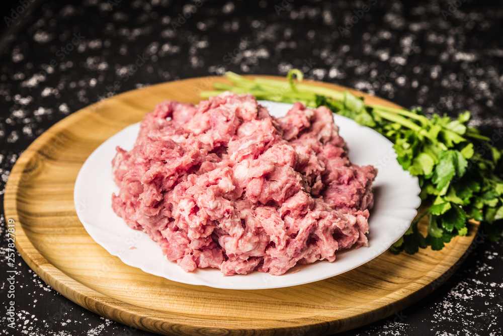 Raw minced pork on white plate