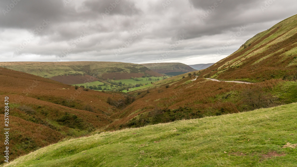 View over the landscape of the Brecon Beacons National Park on a cloudy day, seen from Gospel Pass, Powys, Wales, UK