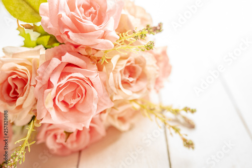 Bouquet of pink roses on white wood background