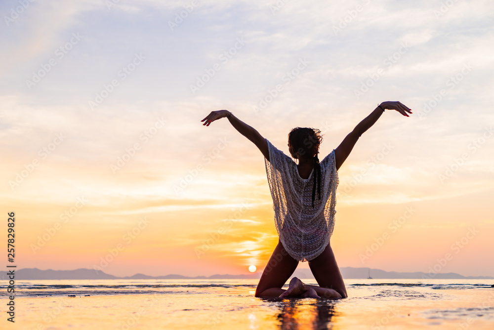 Fototapeta premium Woman on the beach at sunset