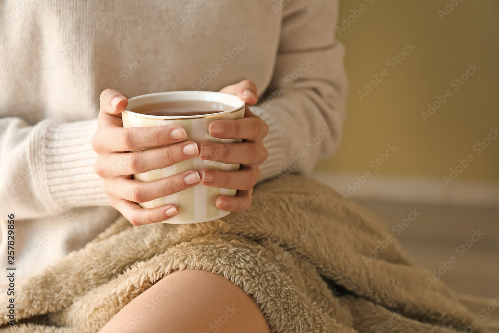 Young woman with cup of hot tea resting at home Young woman with cup of hot tea resting at home