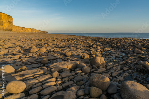 The stones and cliffs of Llantwit Major Beach in the evening sun, South Glamorgan, Wales, UK photo