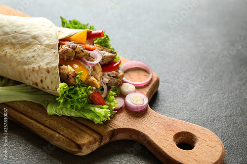 Tasty doner kebab on wooden board photo