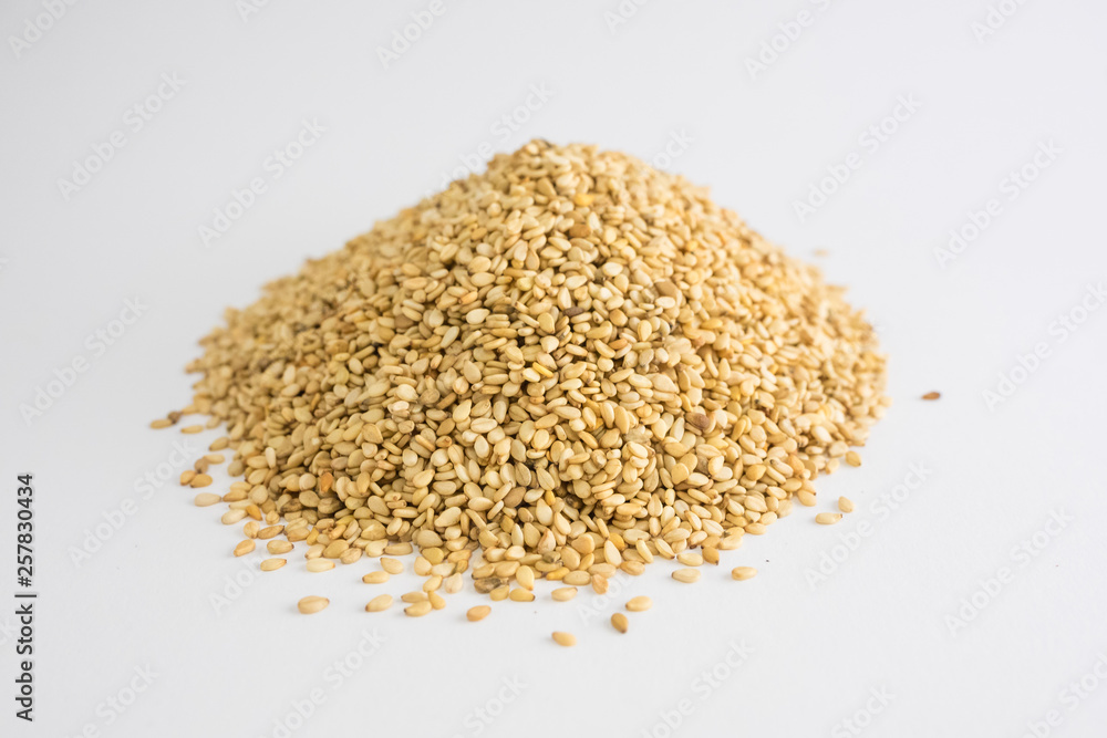 Mountain of sesame seeds on white background Mountain of sesame seeds on white background