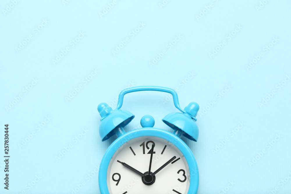Blue alarm clock isolated on blue background. Blue alarm clock isolated on blue background.