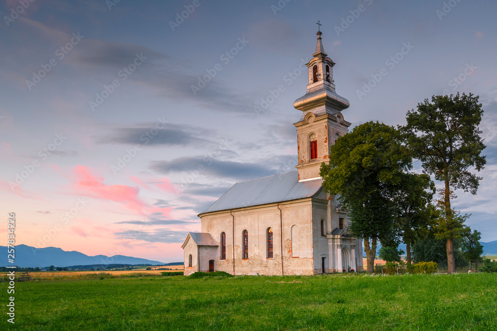 Rural landscape with fields and a church in Turiec region, central Slovakia.