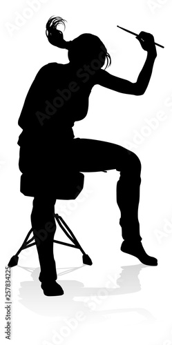 A drummer musician drumming drums in detailed silhouette