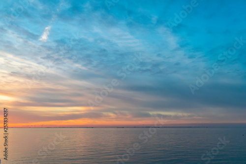 The colorful sky at sunset is reflected in the sea. Seascape with sunset. 