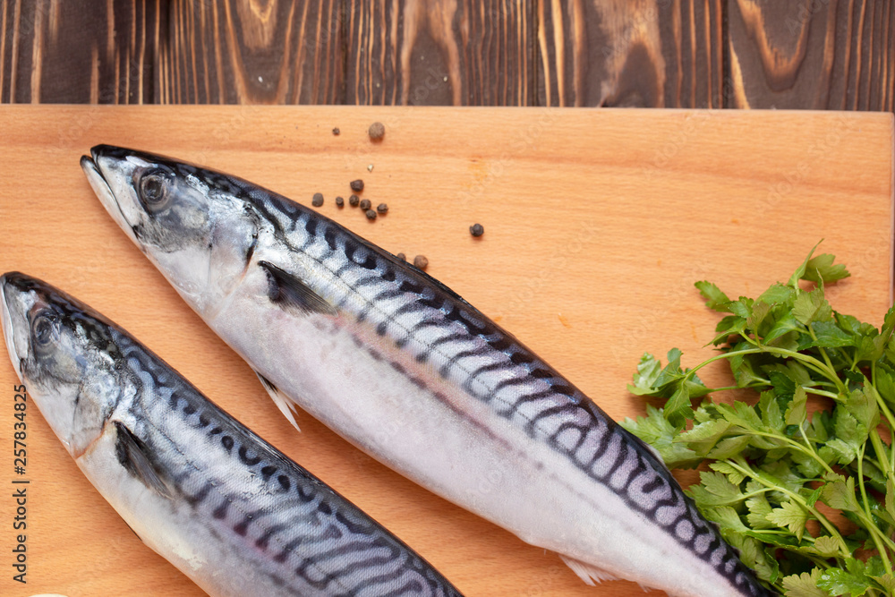 Mackerel on wooden background. Raw fish Top view. Free copy space. Mackerel on wooden background. Raw fish Top view. Free copy space.