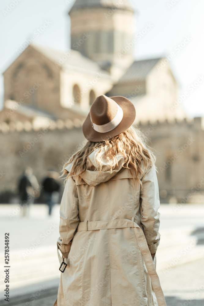 Obraz premium Girl travel blogger outdoors. The ancient capital and the Jvari monastery, Georgia.