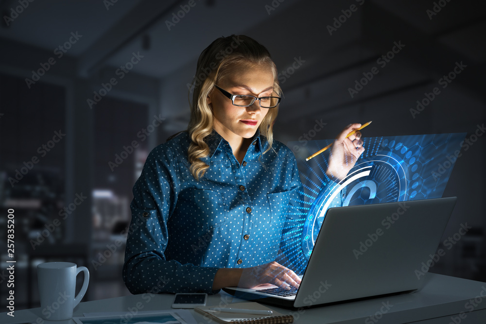 Beautiful blonde in dark office working on laptop and getting net access Beautiful blonde in dark office working on laptop and getting net access
