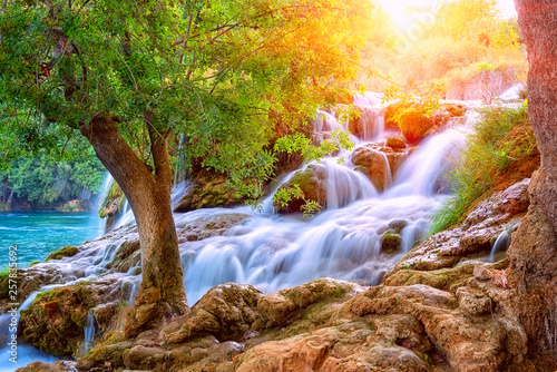Fototapeta Naklejka Na Ścianę i Meble -  Amazing nature landscape, beautiful waterfall at sunrise, famous Skradinski buk, one of the most beautiful waterfalls in Europe and the biggest in Croatia, outdoor travel background