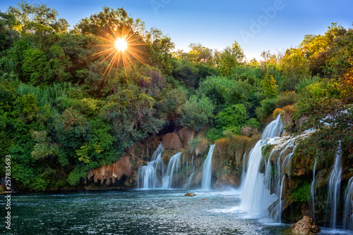 Amazing nature landscape, beautiful waterfall at sunrise, famous Skradinski buk, one of the most beautiful waterfalls in Europe and the biggest in Croatia, outdoor travel background © larauhryn