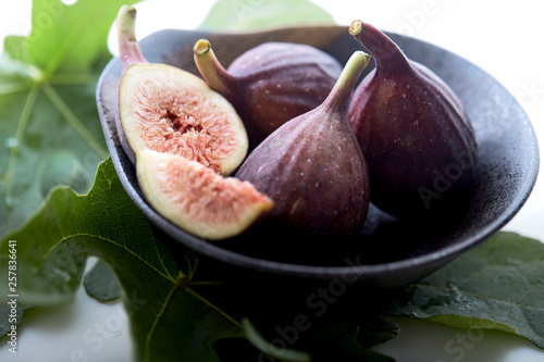 figs in a a bowl with fig leaf