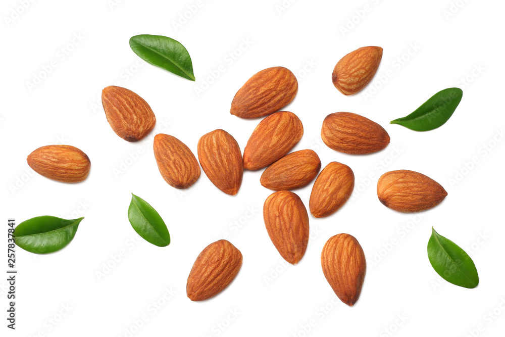 almonds with green leaves isolated on white background. top view. almonds with green leaves isolated on white background. top view.