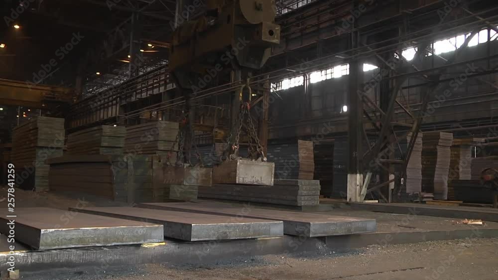The work of the bridge magnetic crane. Lifting sheet metal. The work of the bridge magnetic crane. Lifting sheet metal.