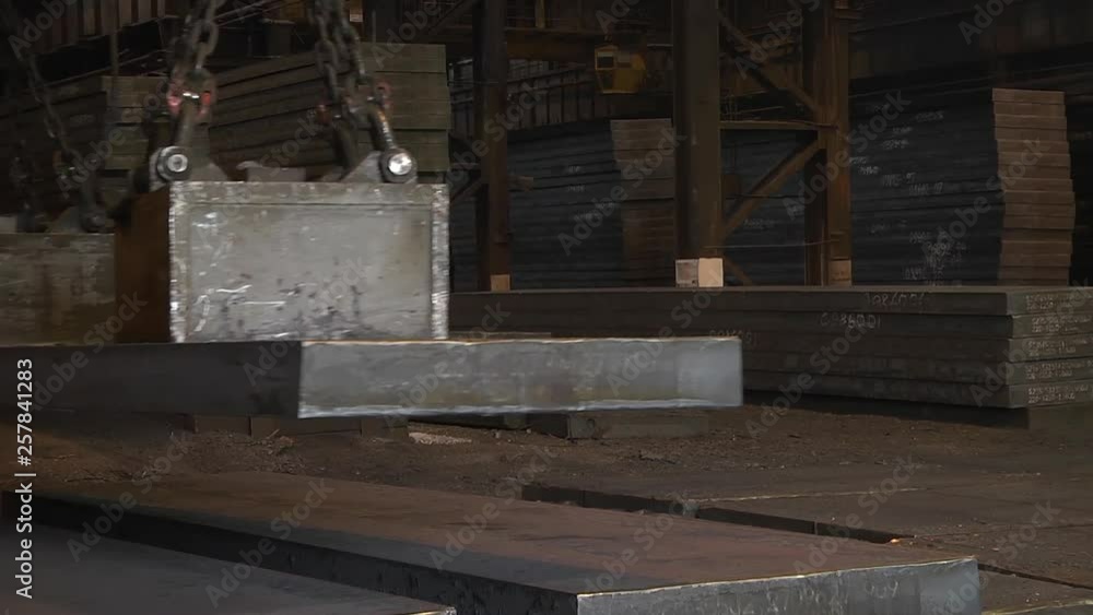 The work of the bridge magnetic crane. Lifting sheet metal. The work of the bridge magnetic crane. Lifting sheet metal.