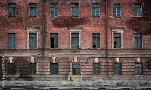 The wall with windows of the abandoned building