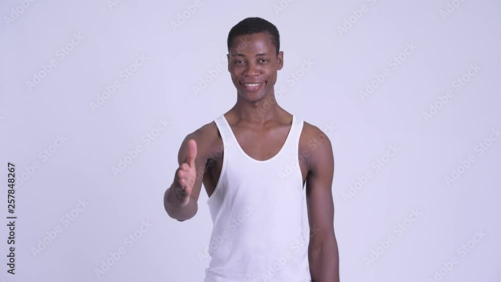 Young happy African man giving handshake Young happy African man giving handshake