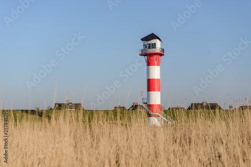 A lighthouse behind the dike in Glueckstadt at the elbe river