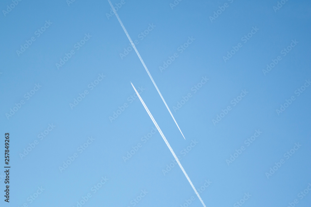 Two airplanes in the blue sky fly to the different ways. Creative concept of relationship. Paths diverged symbol. Two airplanes in the blue sky fly to the different ways. Creative concept of relationship. Paths diverged symbol.
