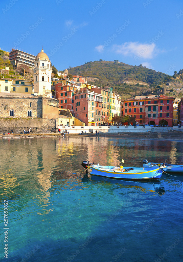 View of the beautiful seaside of Vernazza village with fishing boats in sunny day in the Cinque Terre area, Italy.