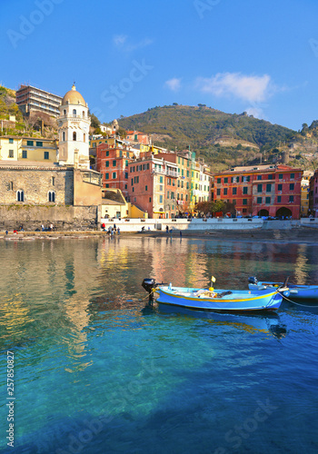 View of the beautiful seaside of Vernazza village with fishing boats in sunny day in the Cinque Terre area, Italy.