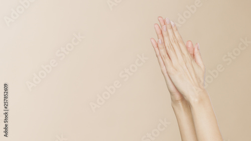 Women s hands on a beige background